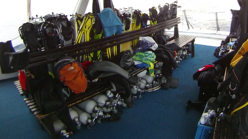 Lots of dive gear on a boat 